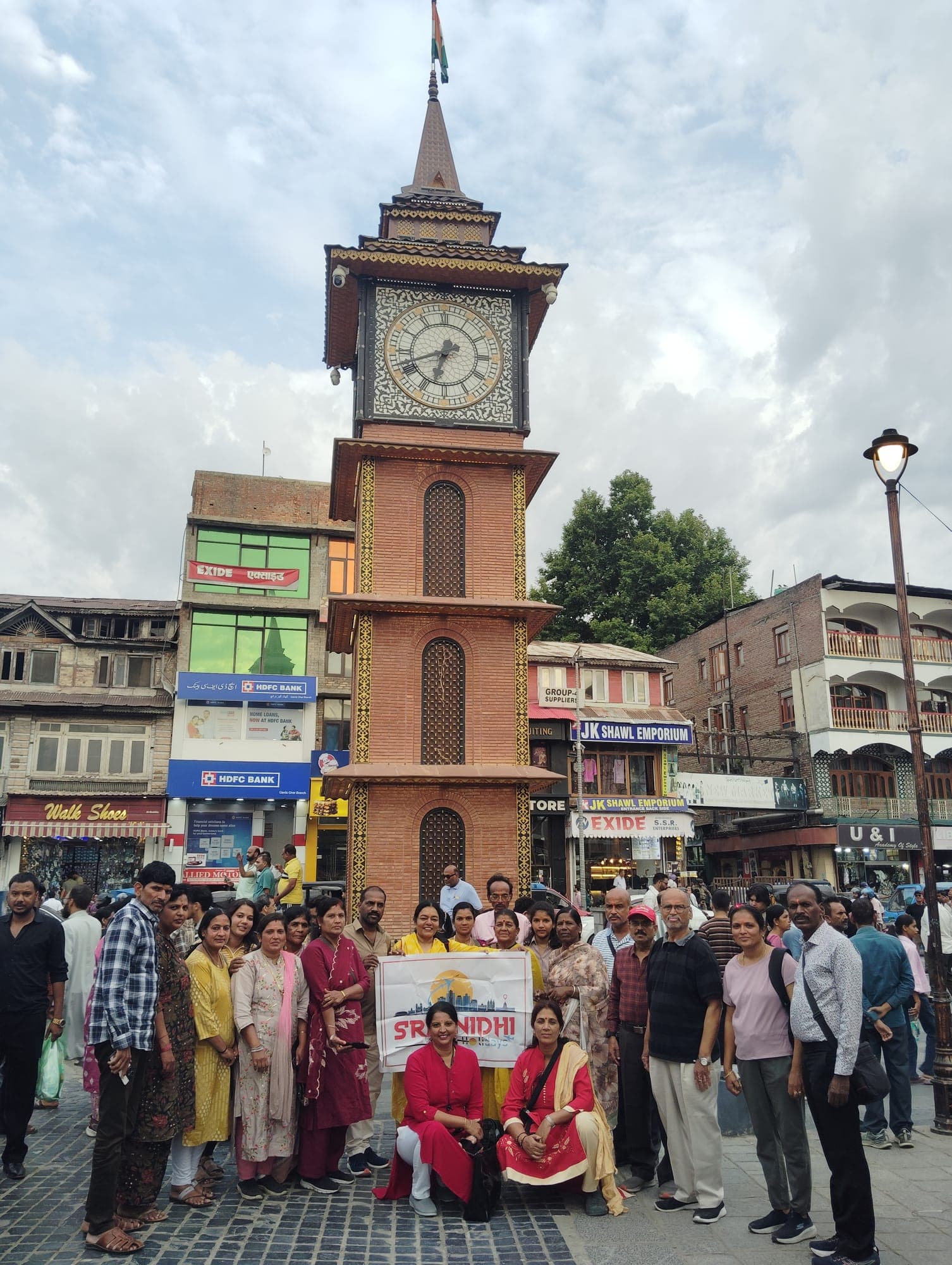 Sreenidhi Holidays group at the Lal Chowk clock tower, Srinagar