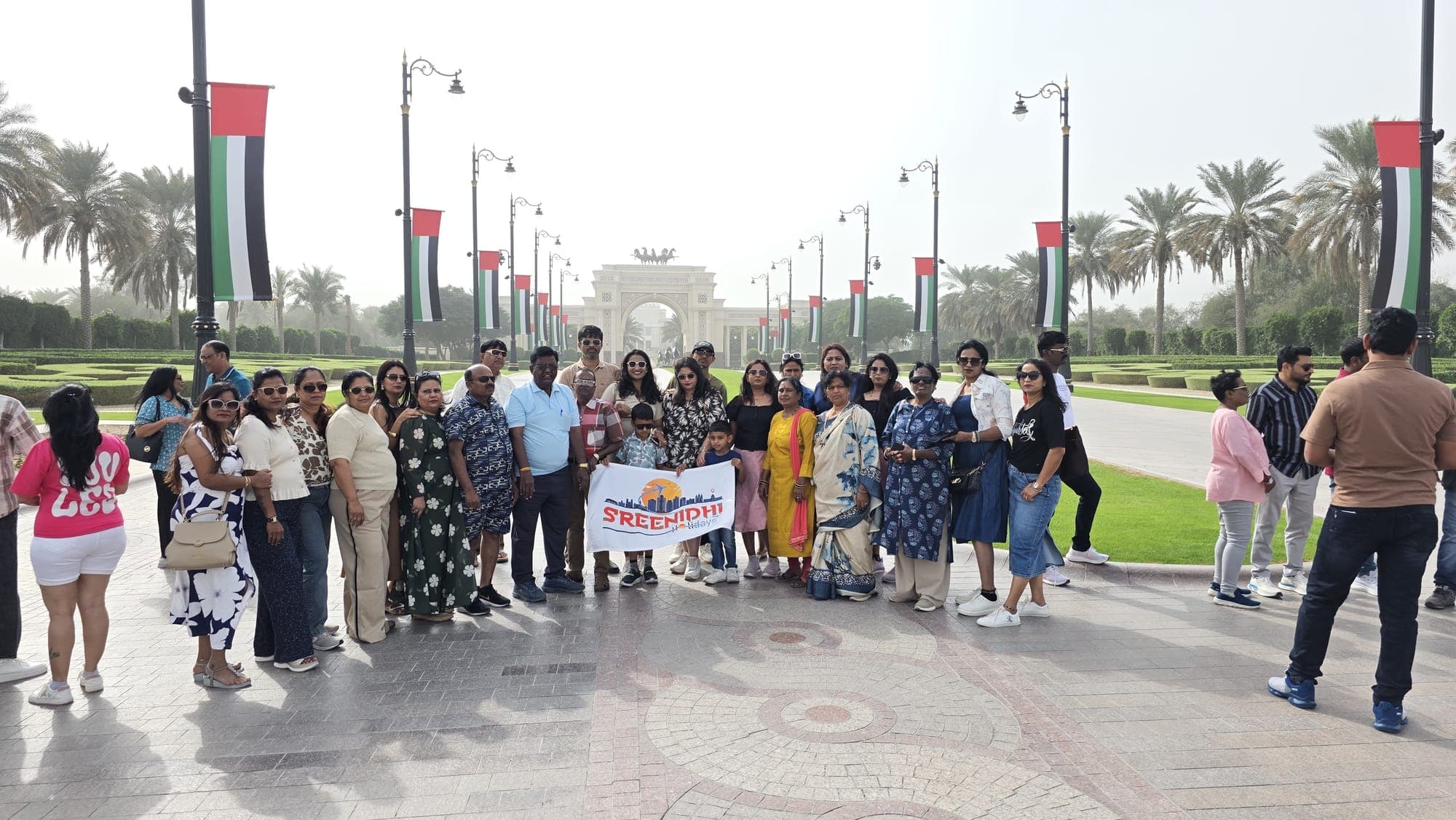 Sreenidhi Holidays group on a flag-lined boulevard in Dubai