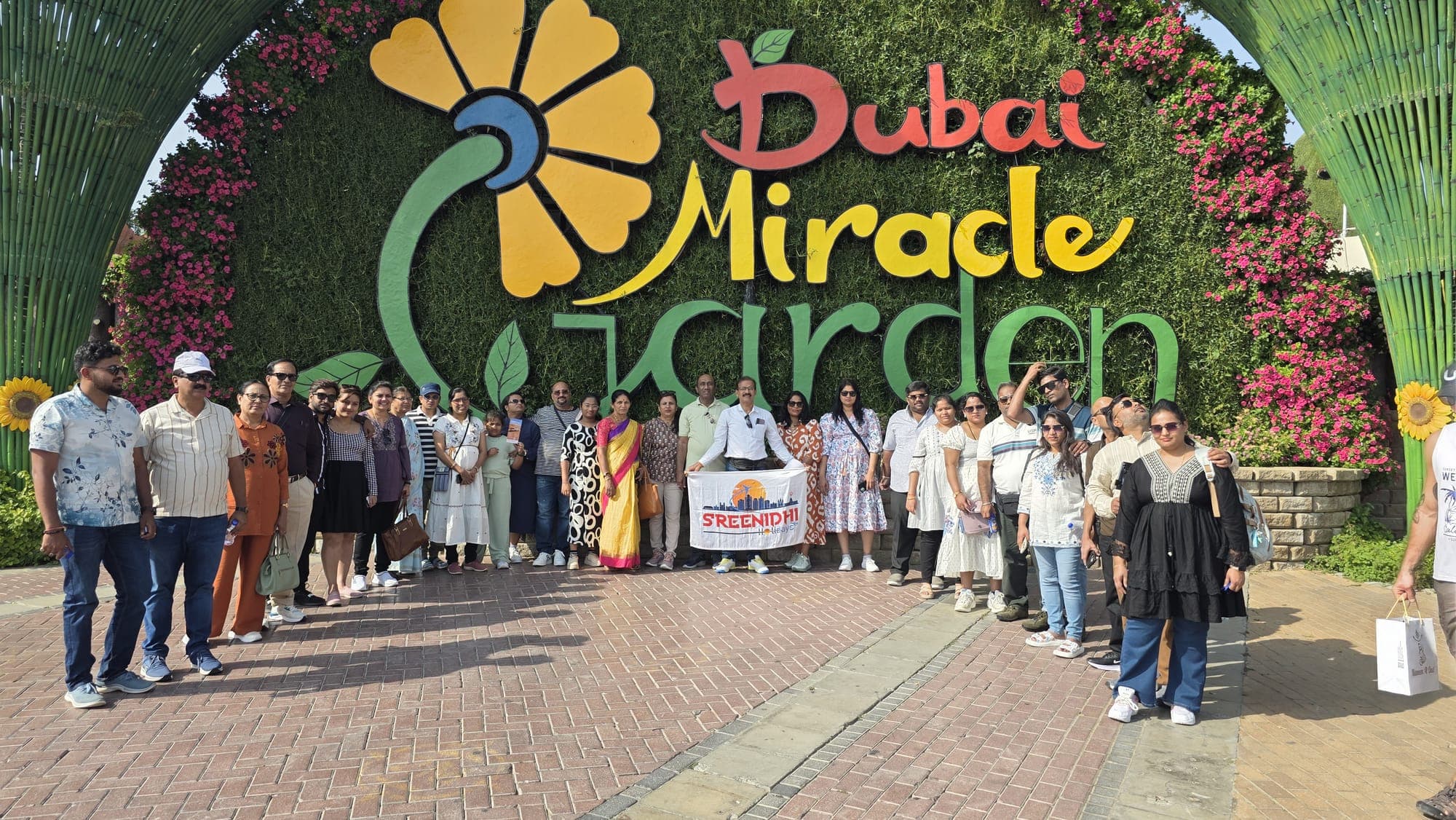 Sreenidhi Holidays group at the entrance of Dubai Miracle Garden