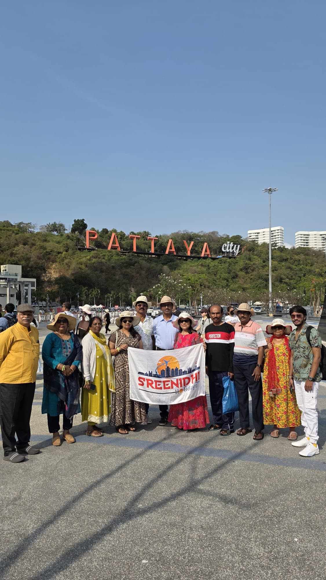 Sreenidhi Holidays group below the Pattaya hillside sign, Thailand