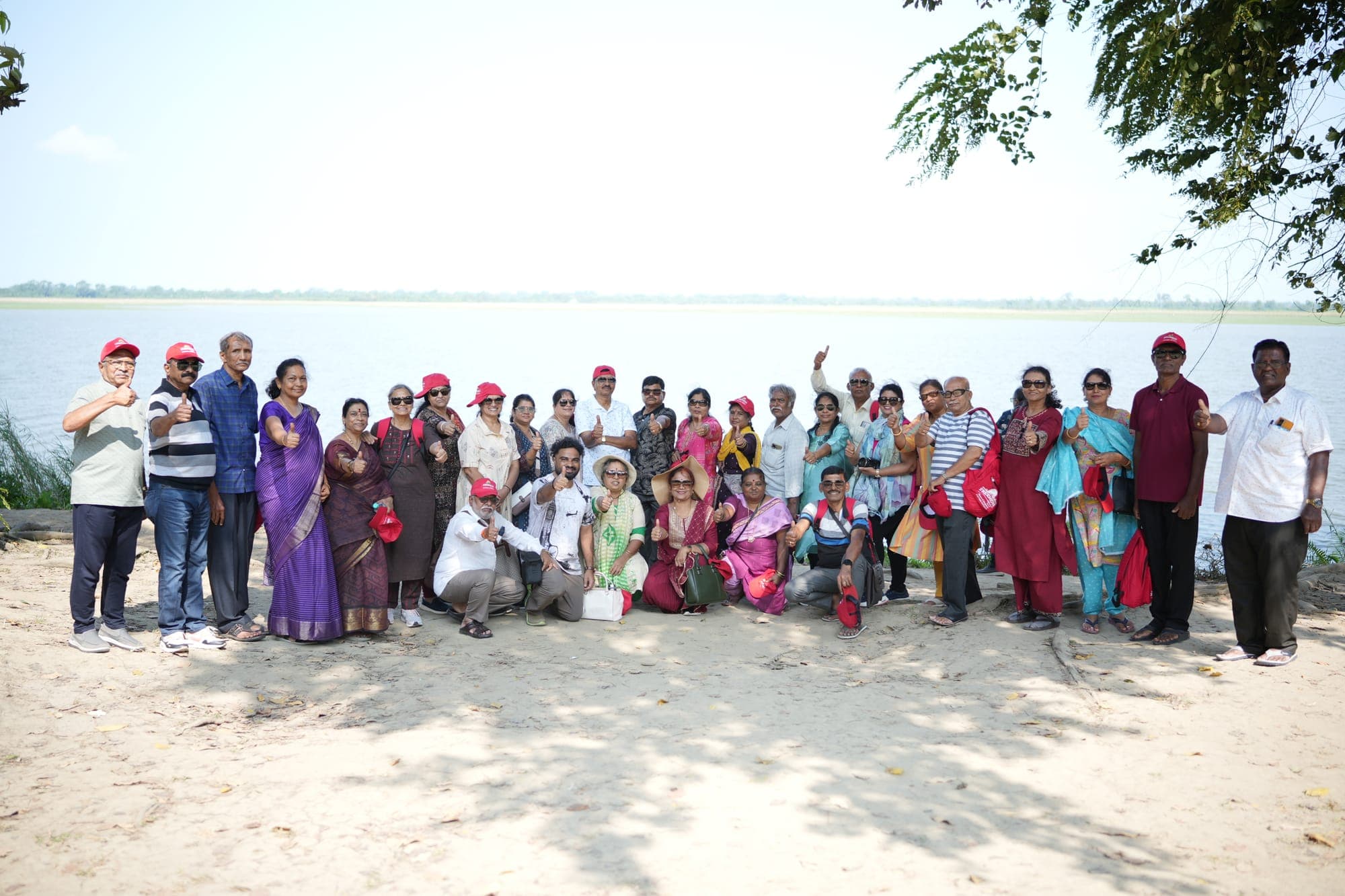 Sreenidhi Holidays group on a sandy riverbank