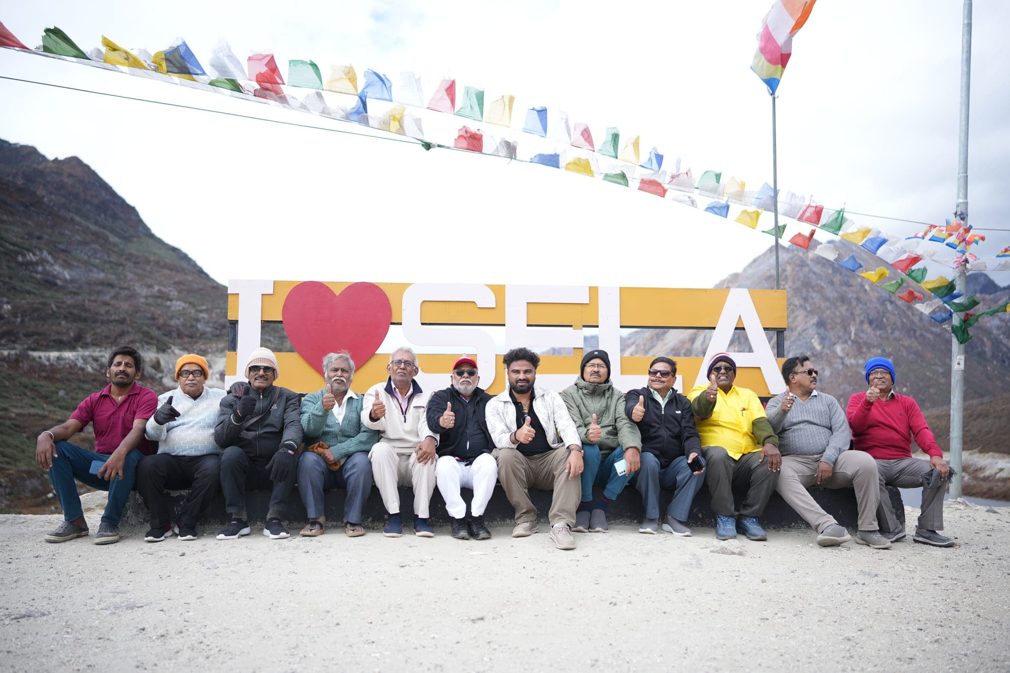 Travellers at the I love Sela sign, Sela Pass, Arunachal Pradesh