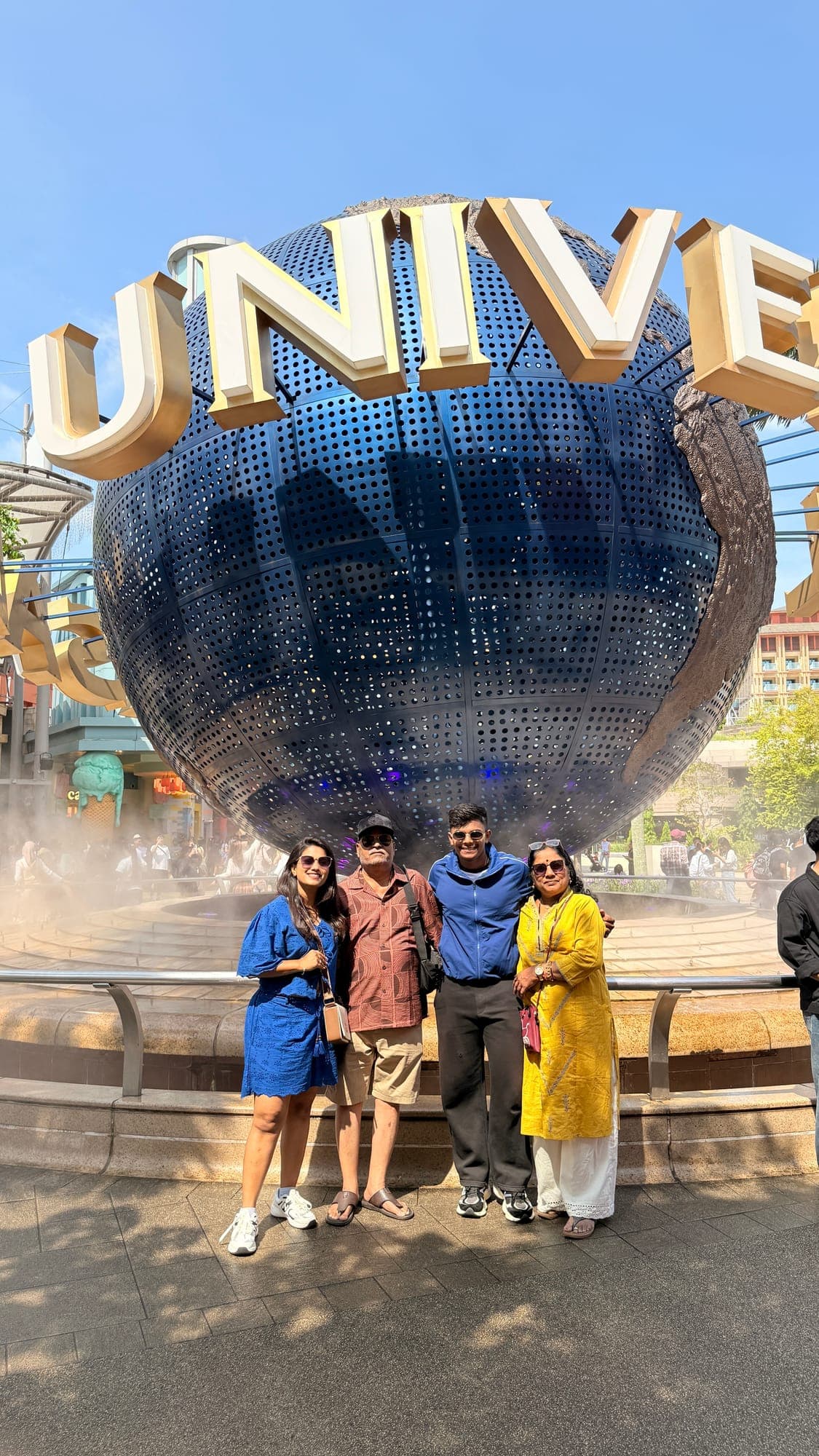 Travellers at the Universal Studios globe, Singapore