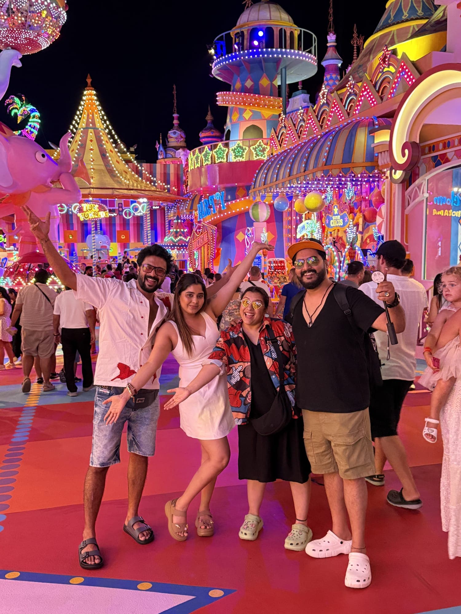 Travellers dancing at a colourful night festival