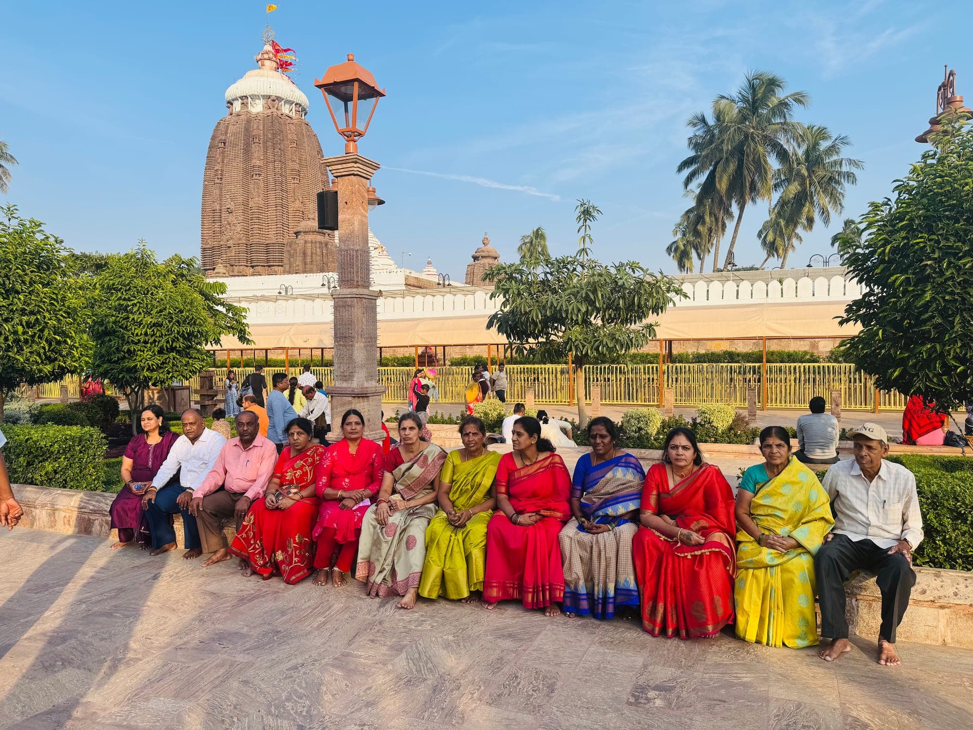 Sreenidhi Holidays pilgrims seated outside a temple