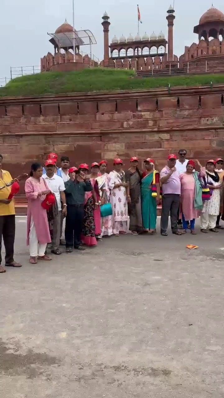 Sreenidhi Holidays group beside red sandstone fort walls