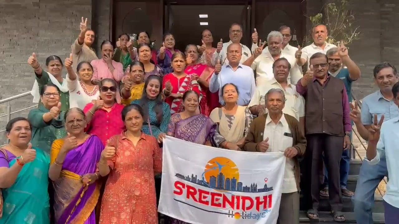 Sreenidhi Holidays group with the banner