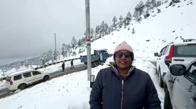 Traveller on a snowy mountain road