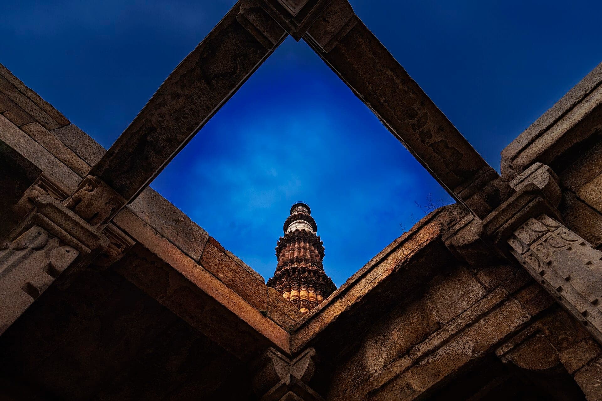 Qutub Minar framed by ancient stonework, Delhi