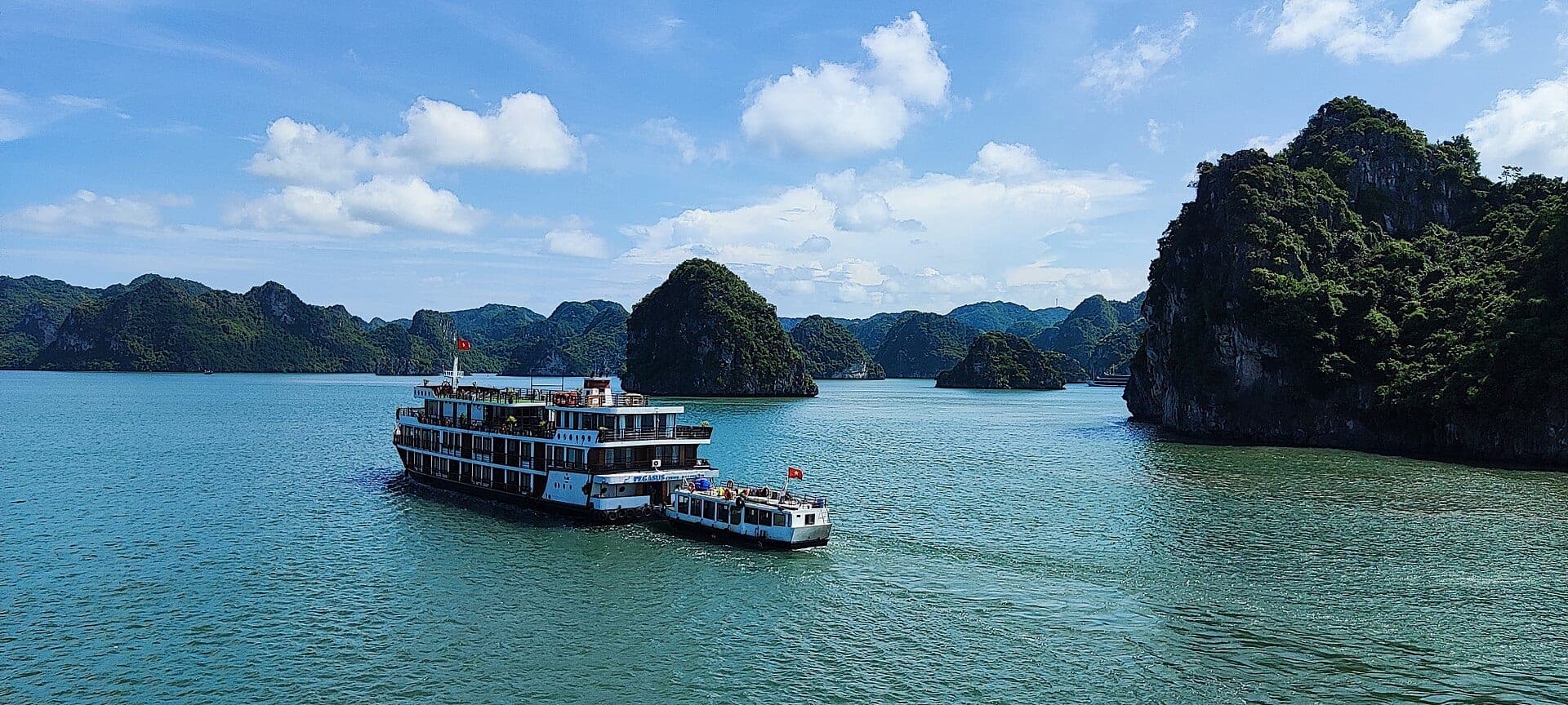 Cruise boat among the karsts of Ha Long Bay